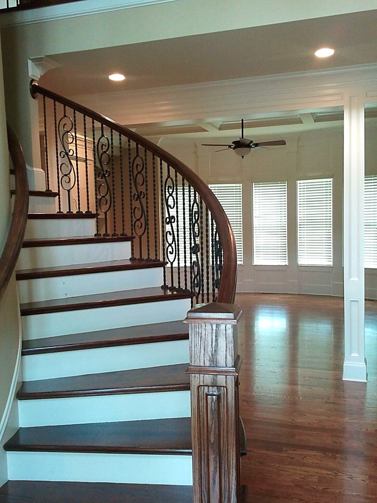 Inspiration for a medium sized modern wood curved metal railing staircase in Atlanta with painted wood risers.
