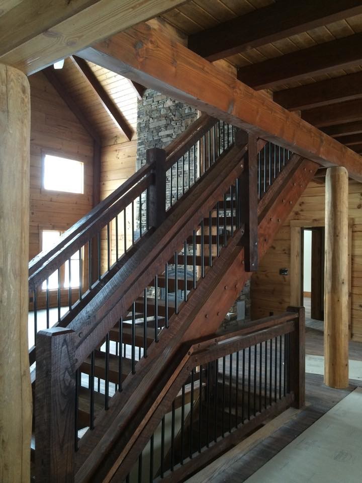 Inspiration for a large rustic wood straight staircase in Other with open risers.