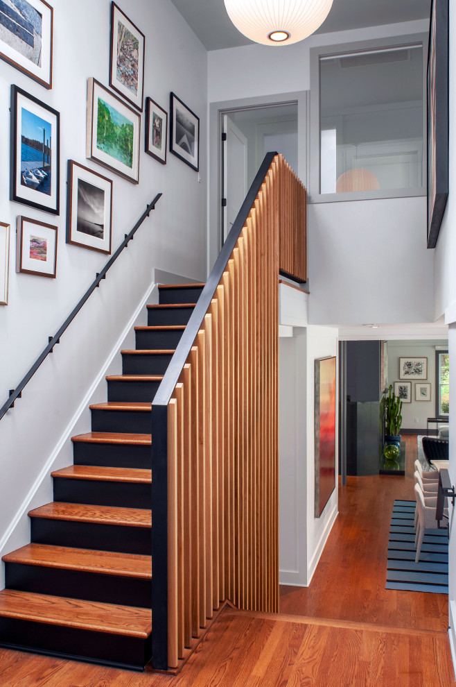 Trendy wooden straight wood railing staircase photo in New York with painted risers