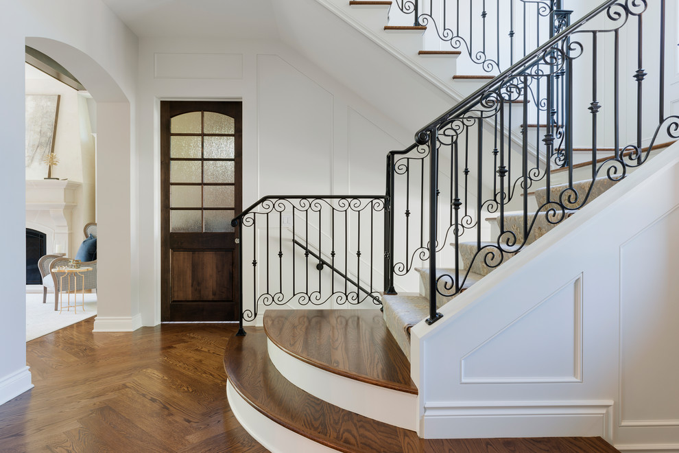 Inspiration for a large mediterranean carpeted u-shaped metal railing staircase remodel in Minneapolis with carpeted risers