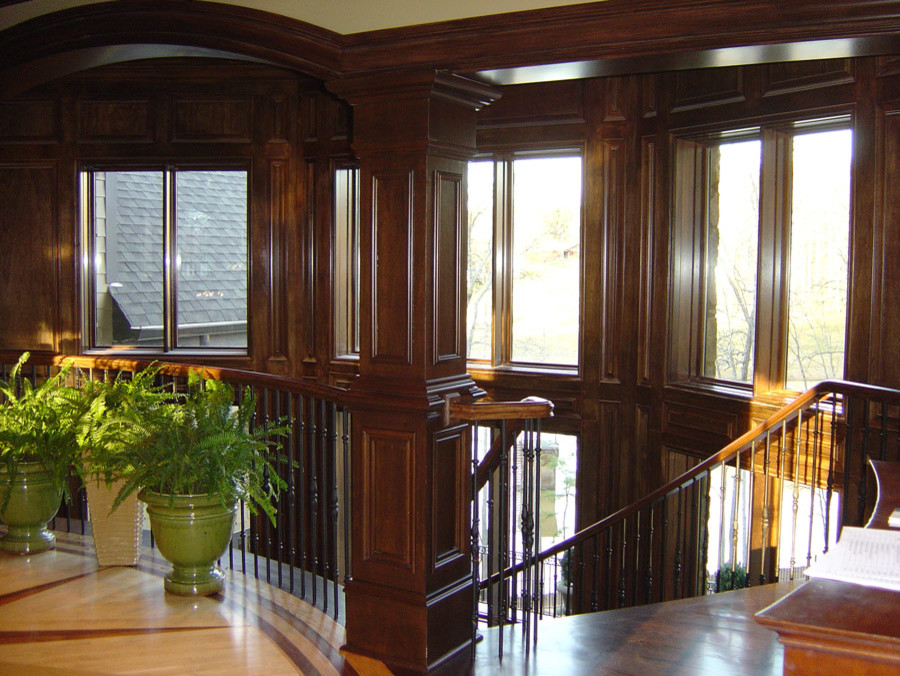 Traditional wood curved staircase in Atlanta with wood risers.