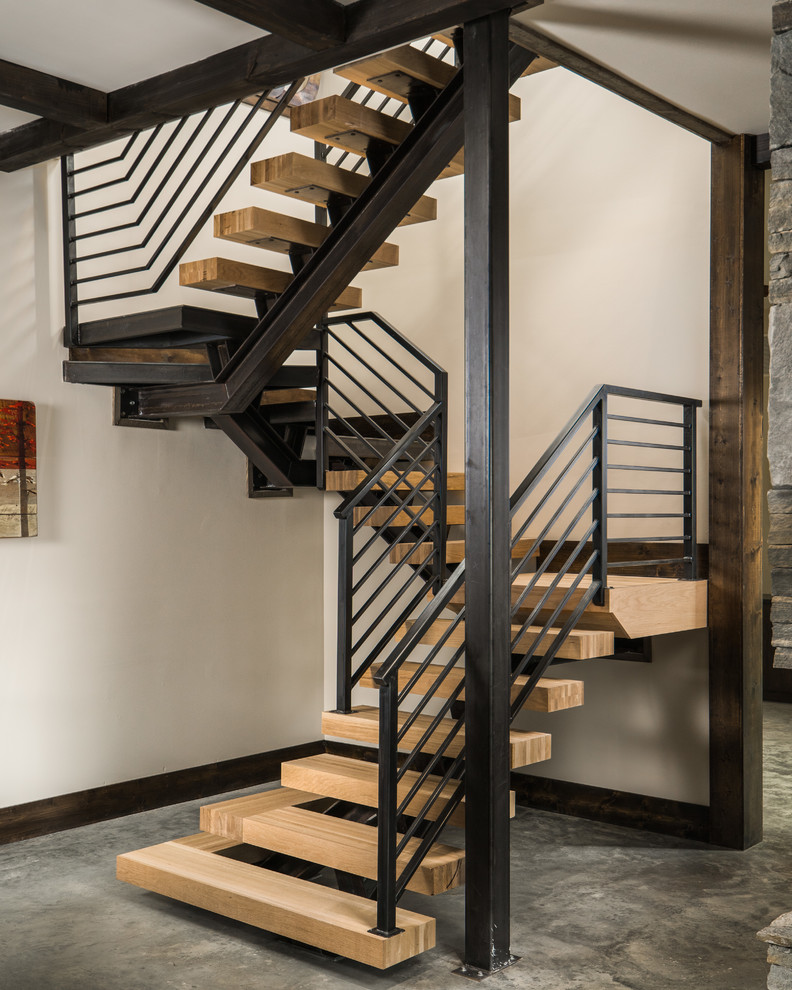 Inspiration pour un escalier sans contremarche flottant chalet avec des marches en bois et un garde-corps en câble.