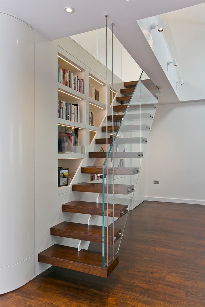 Inspiration for a contemporary wood straight staircase in London with wood risers.