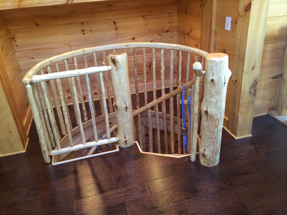 Inspiration for a mid-sized rustic wooden spiral staircase remodel in Grand Rapids with wooden risers