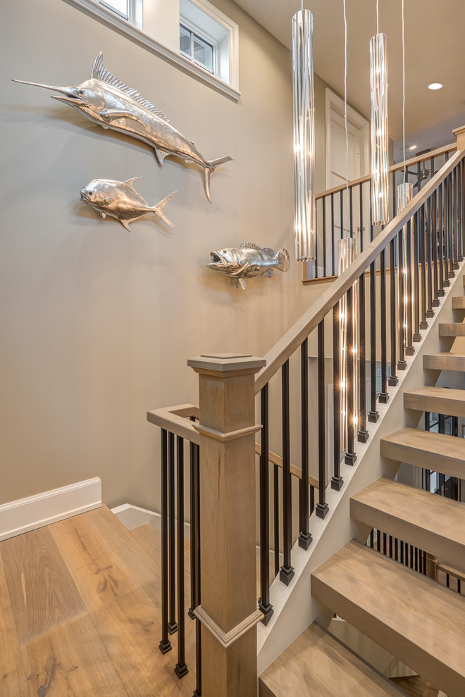 Design ideas for a large contemporary wood u-shaped mixed railing staircase in Other with open risers.