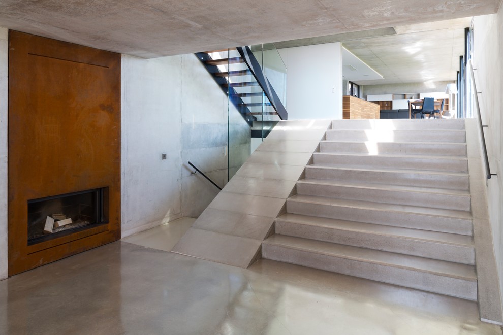 Inspiration for a mid-sized modern concrete straight staircase remodel in Cheshire with concrete risers