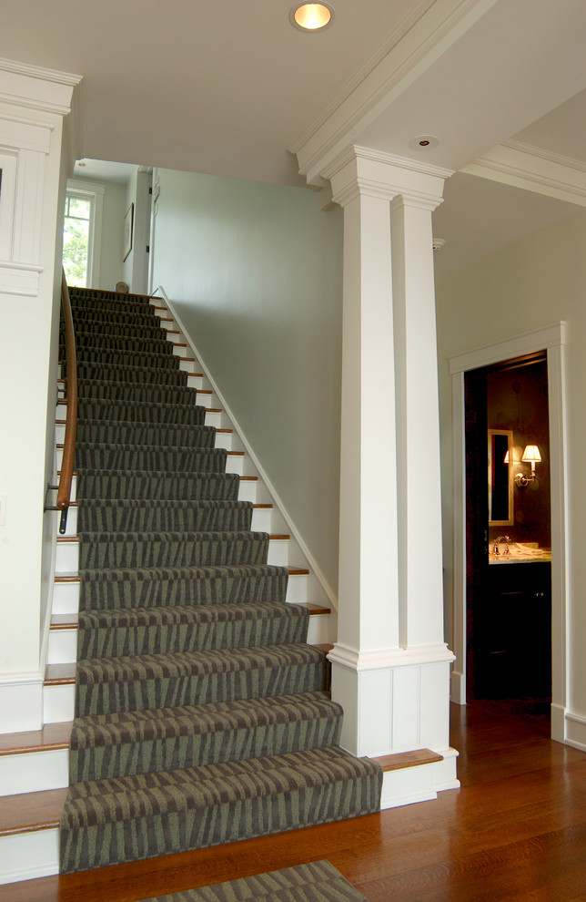 Huge transitional wooden straight staircase photo in Boston with painted risers