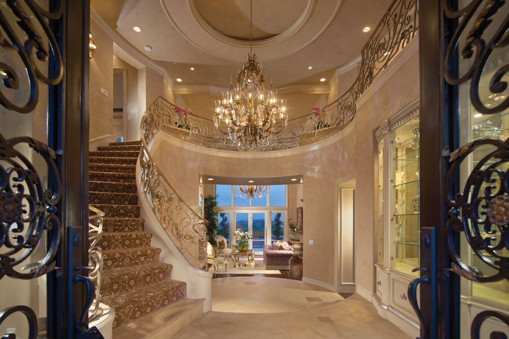 This is an example of a traditional carpeted curved staircase in Orange County with carpeted risers.