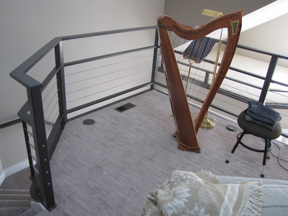 Medium sized modern carpeted curved staircase in Jackson with carpeted risers.