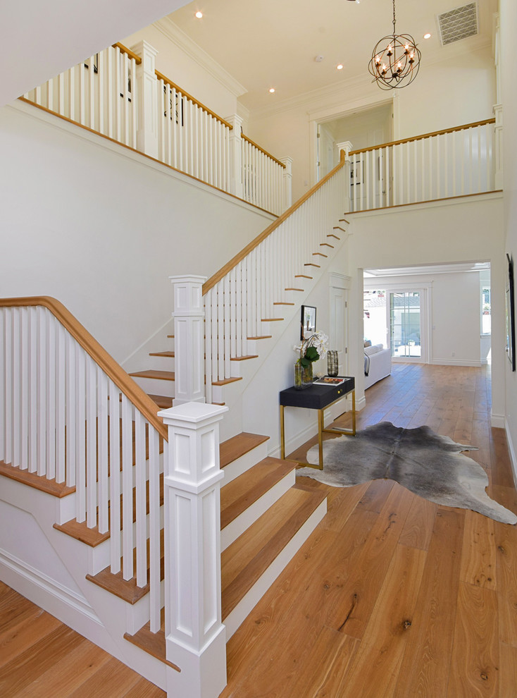 Medium sized traditional wood l-shaped staircase in Los Angeles with painted wood risers.