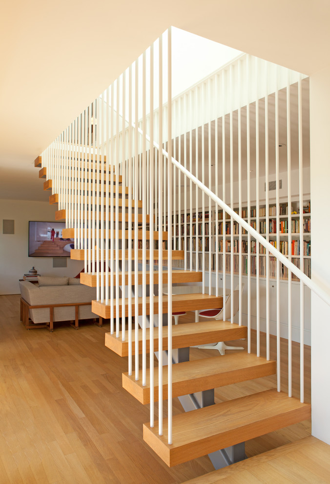 Inspiration for a large midcentury wood straight metal railing staircase in Los Angeles with open risers.