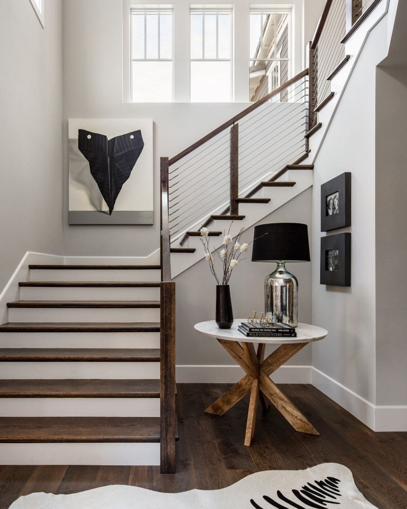 Transitional wooden u-shaped cable railing staircase photo in San Francisco with painted risers