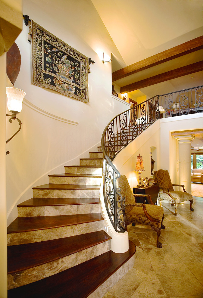 Example of a large tuscan wooden curved staircase design in San Francisco with tile risers