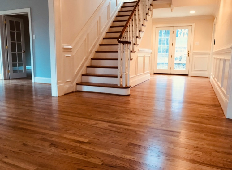Photo of a large classic wood straight wood railing staircase in Philadelphia with painted wood risers.