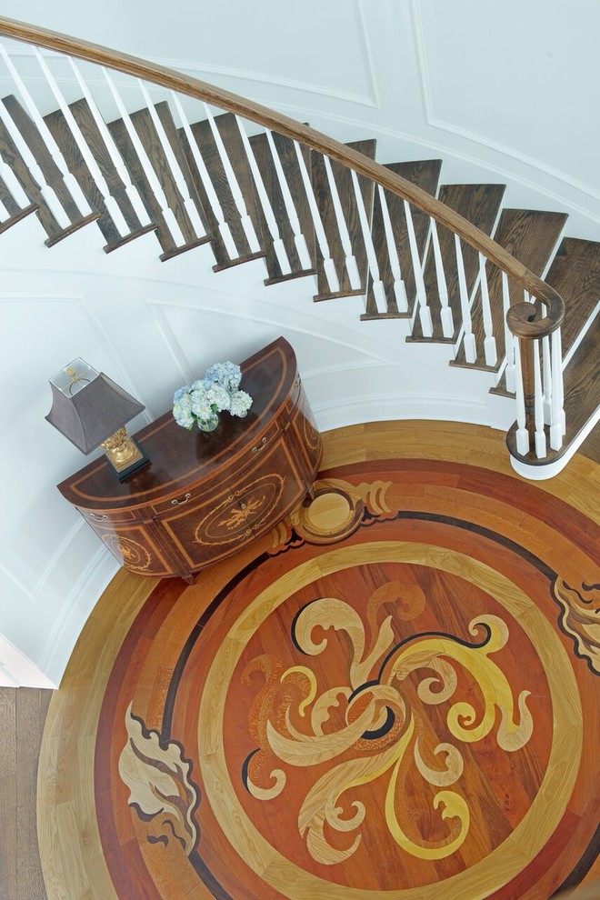 Inspiration for a large timeless wooden curved staircase remodel in New York with painted risers