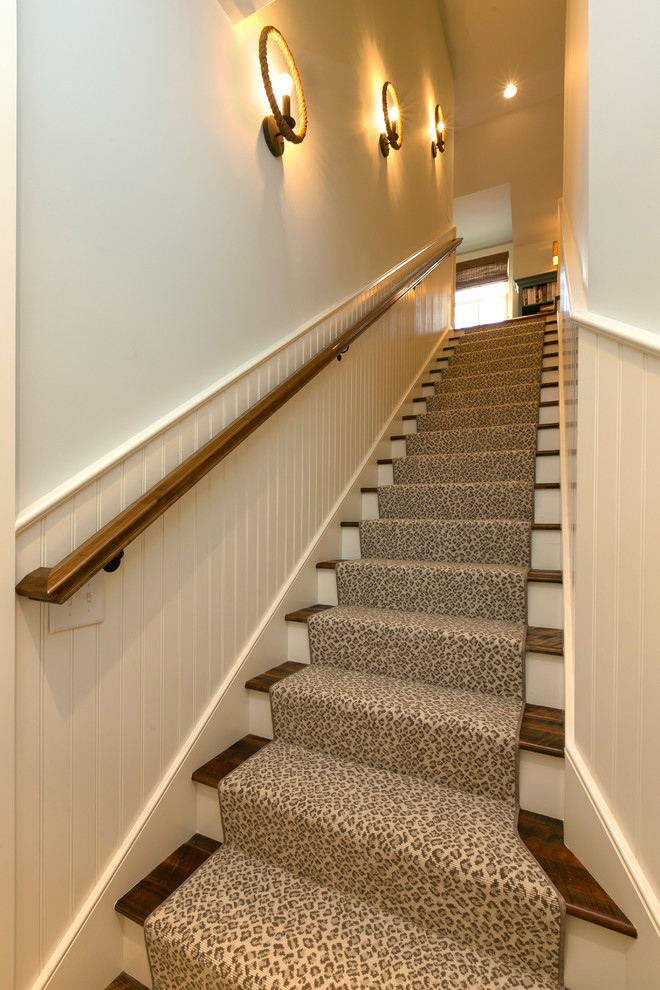 На фото: прямая лестница в классическом стиле с ступенями с ковровым покрытием и крашенными деревянными подступенками с