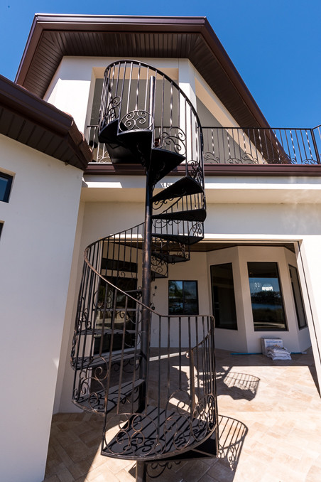 This is an example of a mediterranean metal spiral staircase in Orlando with metal risers.