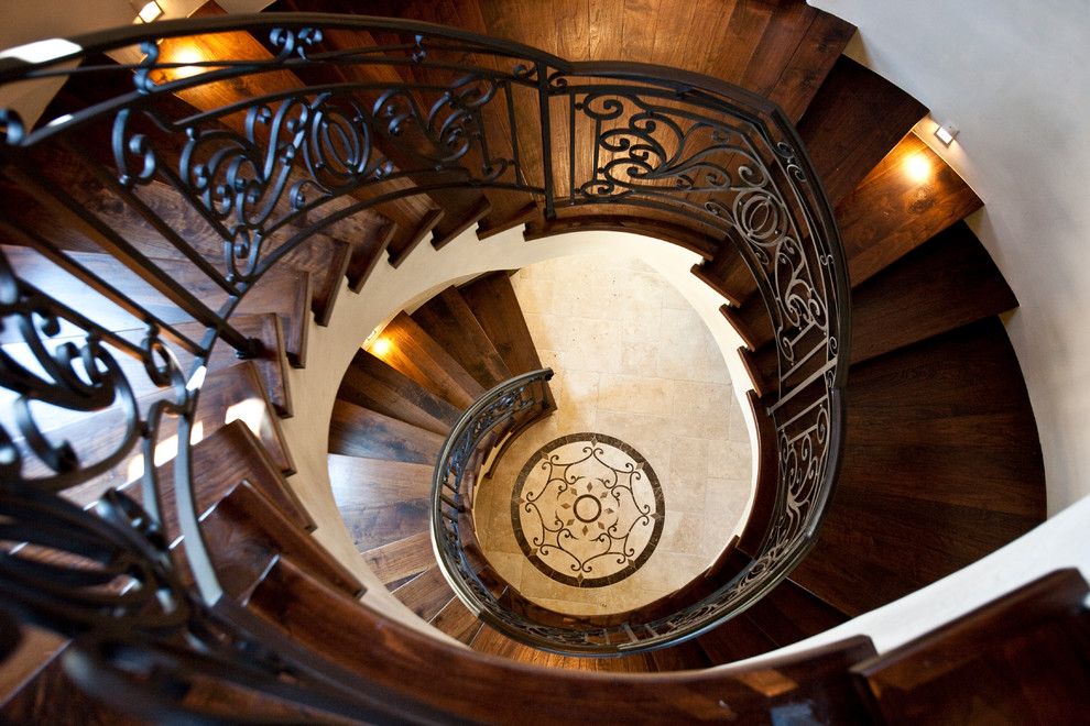 Design ideas for an expansive mediterranean wood spiral staircase in Houston with wood risers.