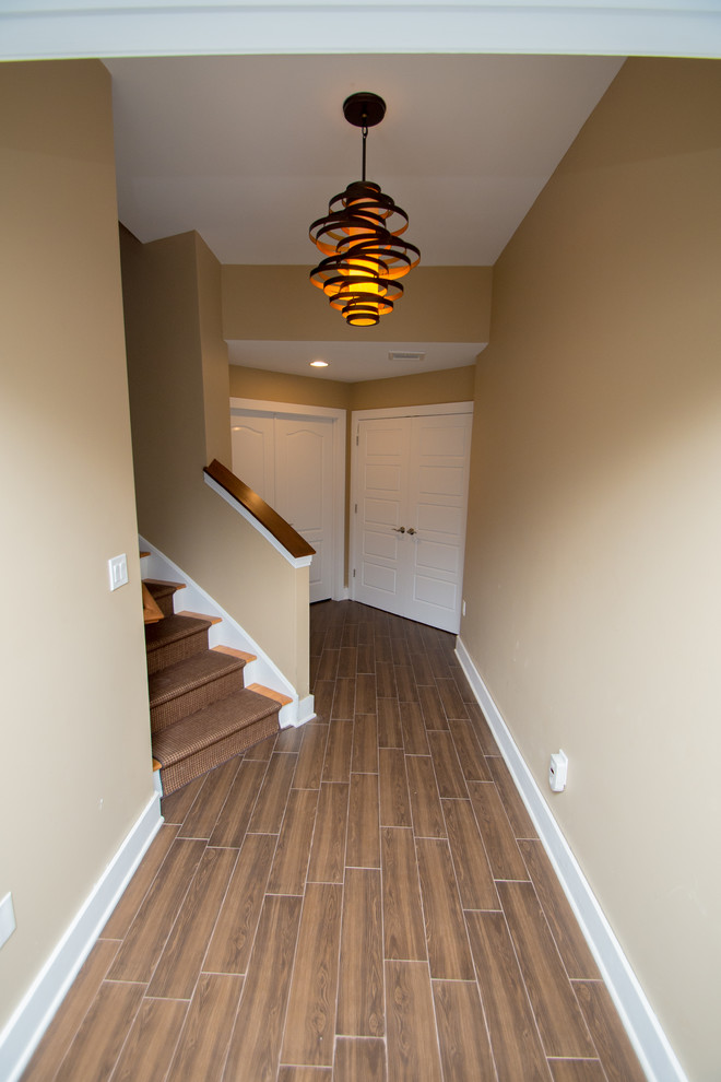 Example of a large classic wooden curved staircase design in New York with painted risers