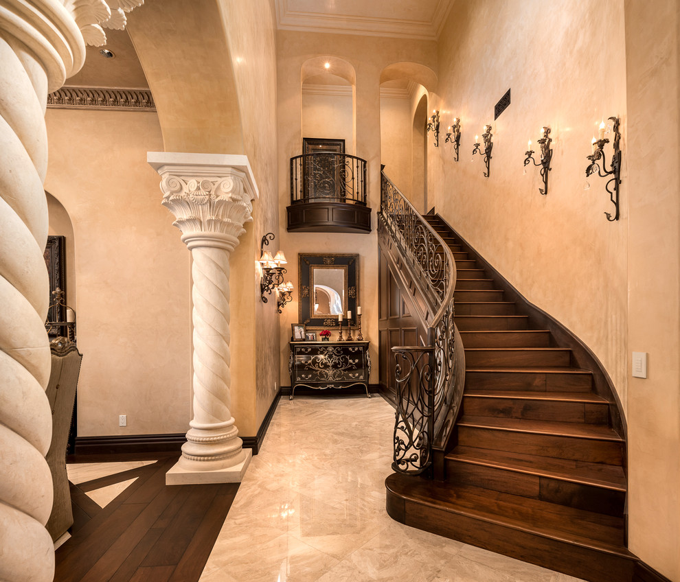 Example of a huge tuscan wooden straight mixed material railing staircase design in Phoenix with wooden risers