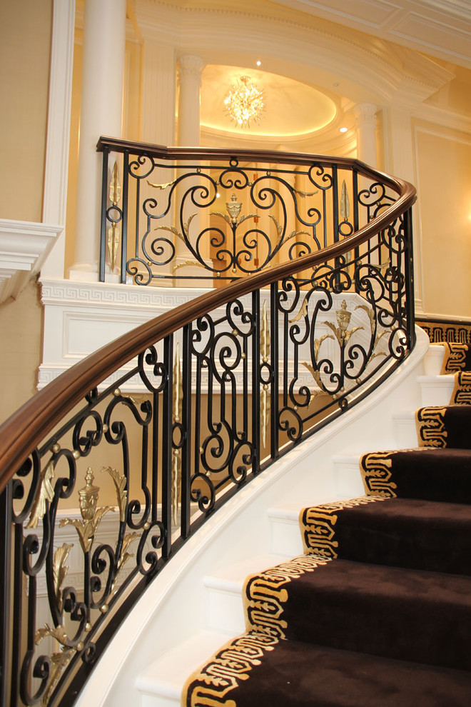 This is an example of a large traditional carpeted curved staircase in Chicago with carpeted risers.