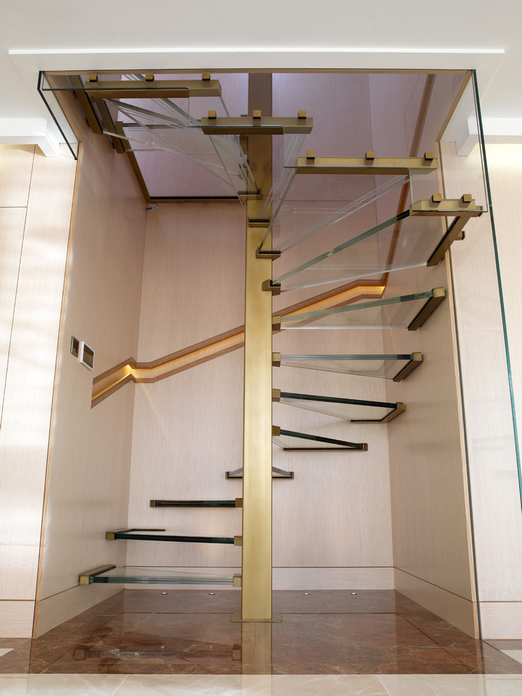 Inspiration for a contemporary glass spiral staircase in London with open risers.