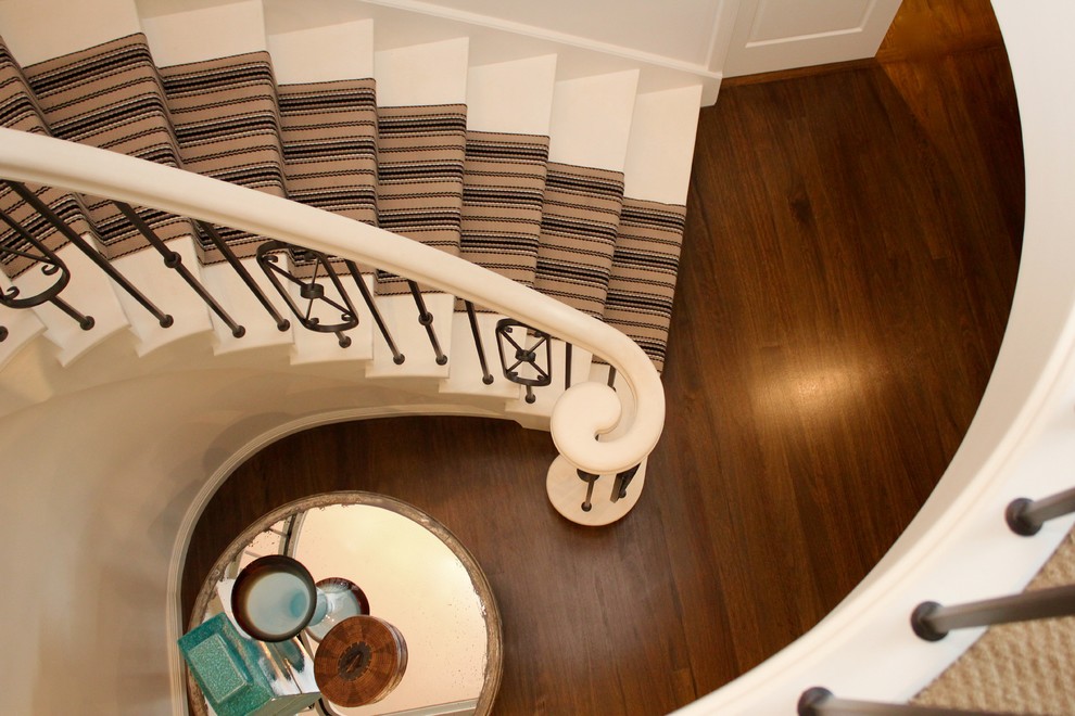 Large elegant wooden curved wood railing staircase photo in Sydney with wooden risers