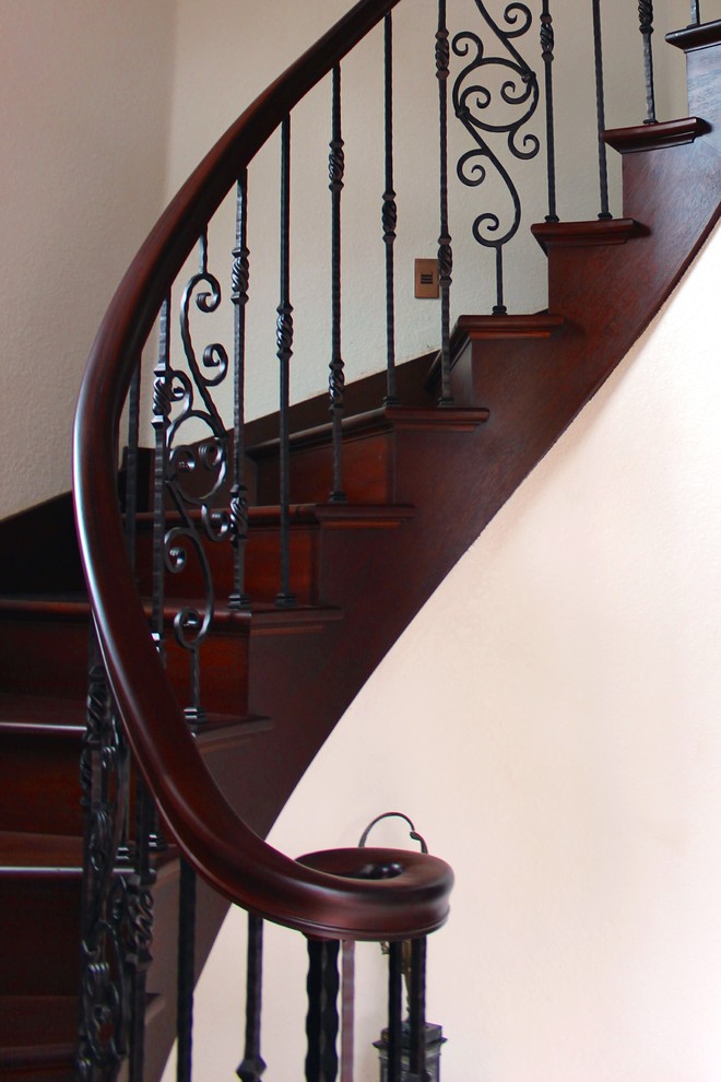 Photo of a mediterranean wood wood railing staircase in Other with wood risers.