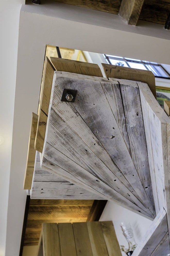 This is an example of a medium sized rustic wood l-shaped staircase in Vancouver with wood risers.