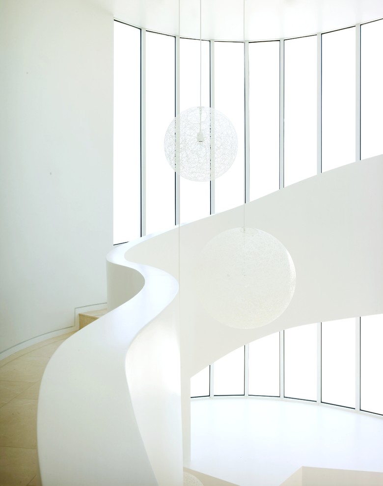 Пример оригинального дизайна: изогнутая лестница в современном стиле с ступенями из плитки и подступенками из плитки