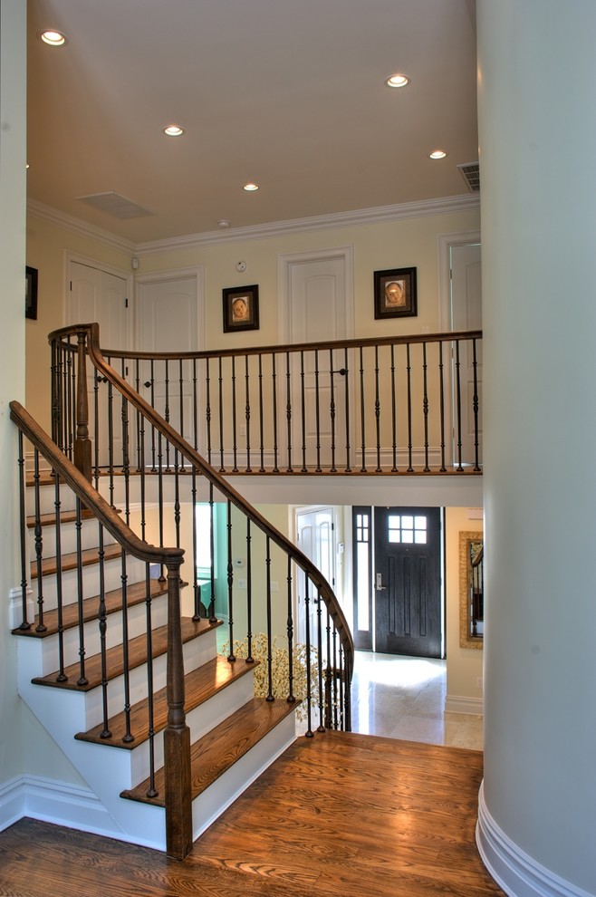 Staircase - large traditional wooden l-shaped wood railing staircase idea in New York with painted risers