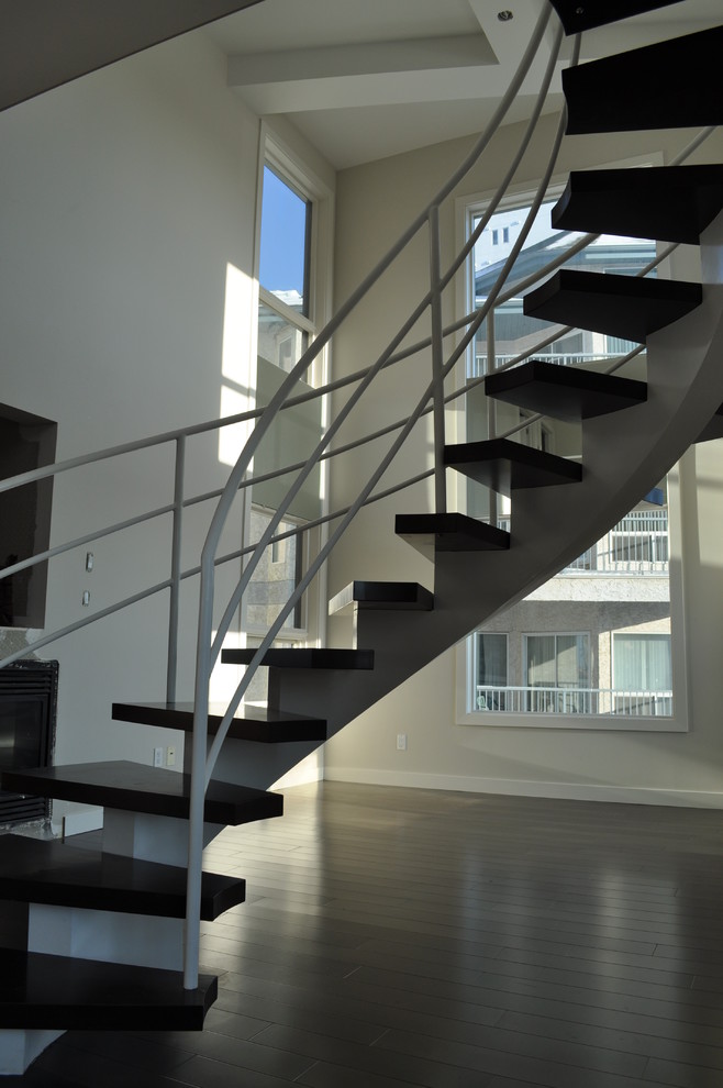 Design ideas for a medium sized modern wood floating staircase in Edmonton with open risers.