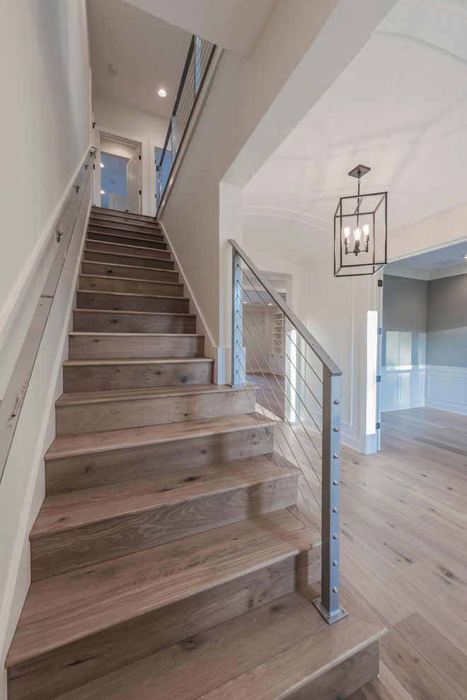 Example of a large transitional wooden straight staircase design in Jacksonville with wooden risers