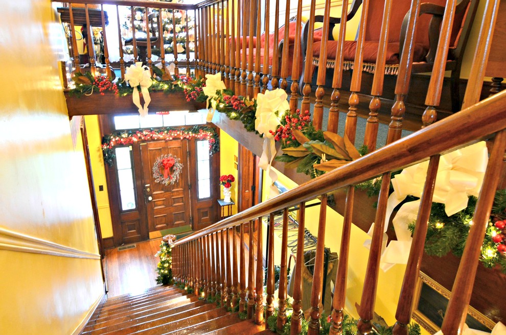 Idée de décoration pour un petit escalier victorien en U avec des marches en bois, des contremarches en bois et un garde-corps en bois.