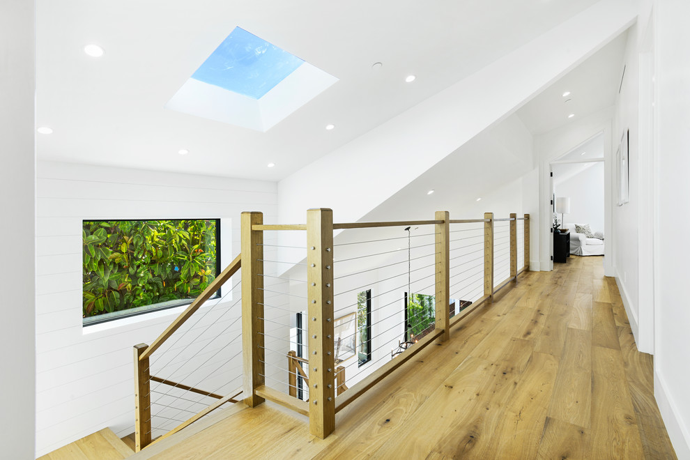 Ejemplo de escalera en U de estilo de casa de campo grande con escalones de madera, contrahuellas de madera y barandilla de madera