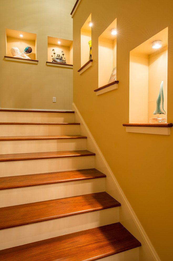 This is an example of a medium sized contemporary wood u-shaped staircase in Charlotte with painted wood risers.