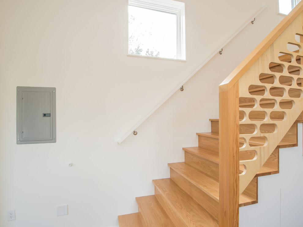 Inspiration for a mid-sized modern wooden straight wood railing staircase remodel in Portland with wooden risers