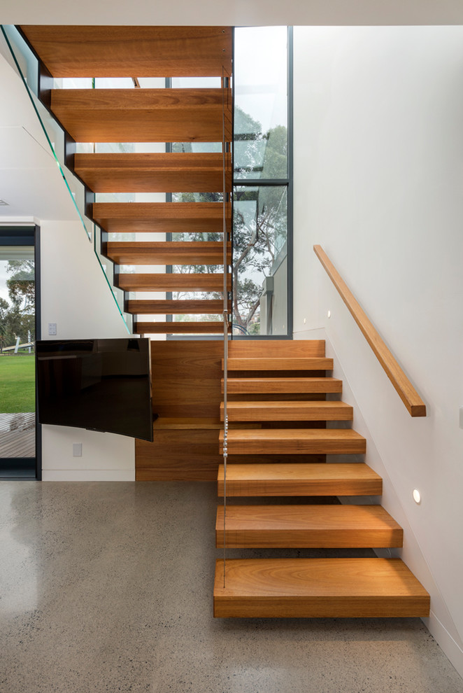 Medium sized contemporary wood floating wood railing staircase in Melbourne with open risers.