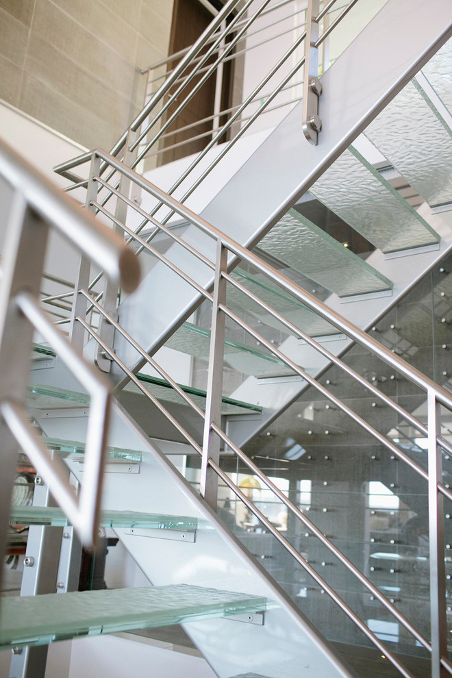 Example of a large urban glass u-shaped open staircase design in Vancouver