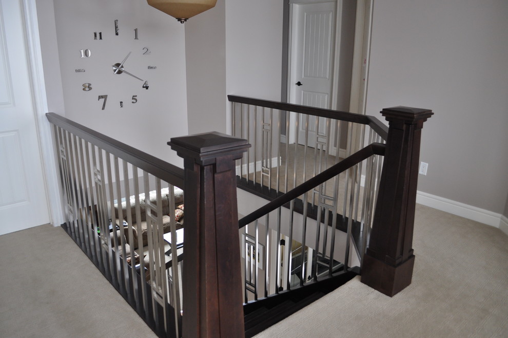 Medium sized modern wood u-shaped staircase in Calgary with open risers.