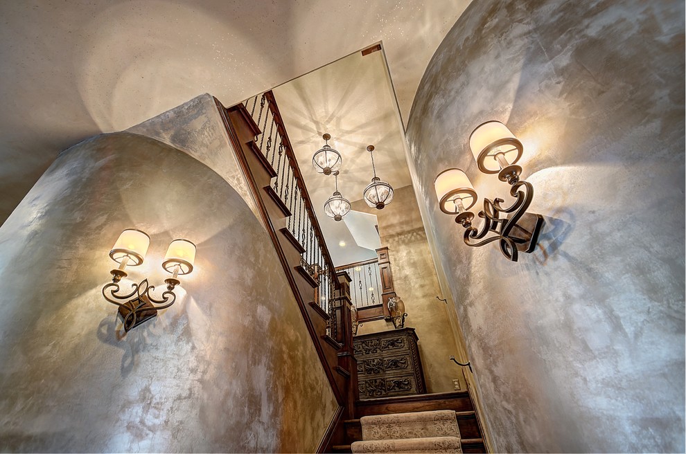 Expansive rustic wood u-shaped staircase in Salt Lake City with carpeted risers.