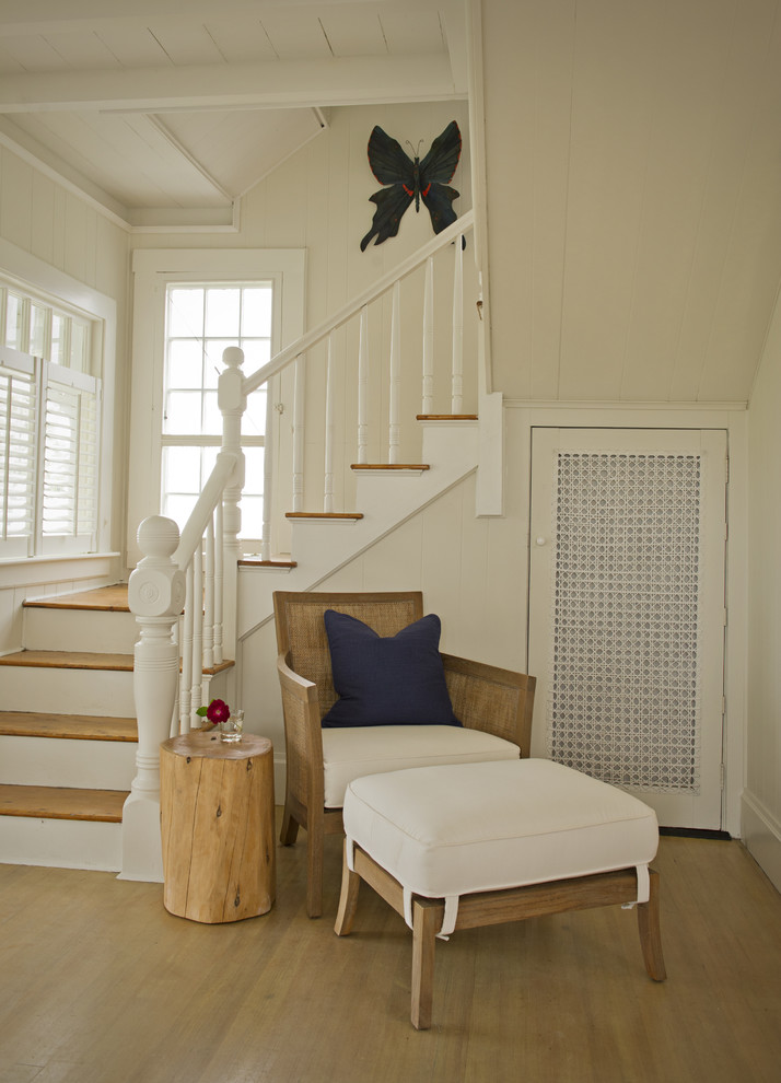 Photo of a medium sized classic wood l-shaped staircase in Boston with painted wood risers.