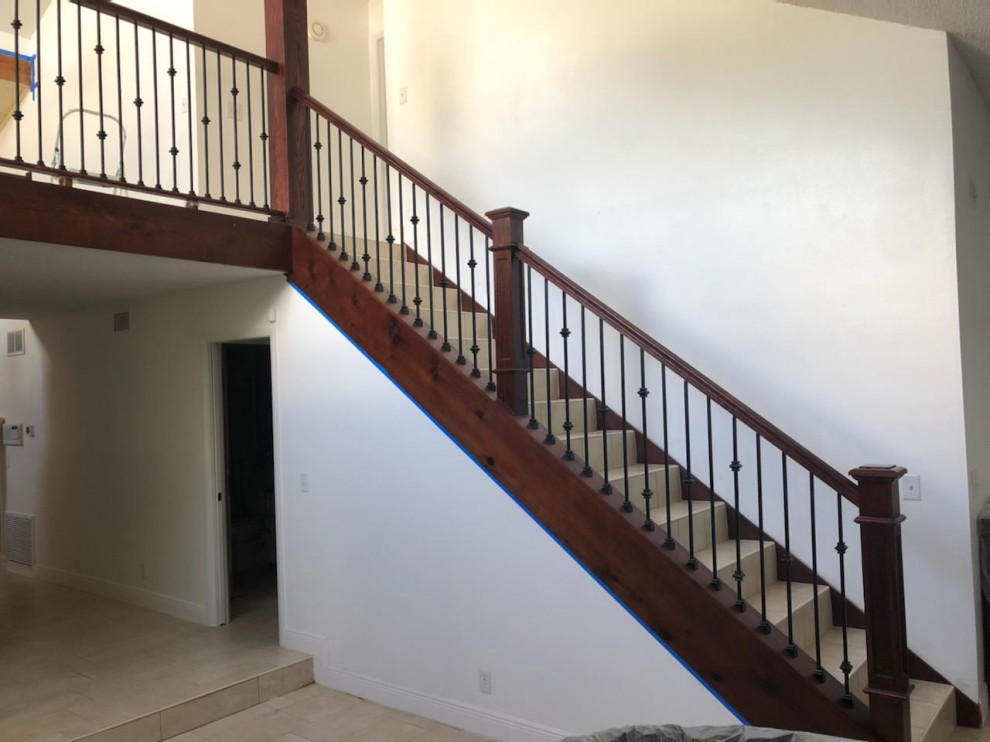 Medium sized victorian straight wood railing staircase in Tampa with wood risers and wood walls.