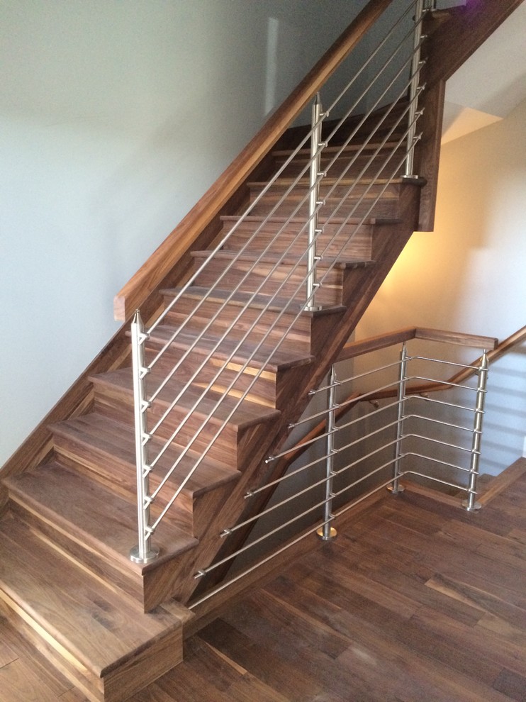 Small modern wood l-shaped staircase in Other with wood risers.