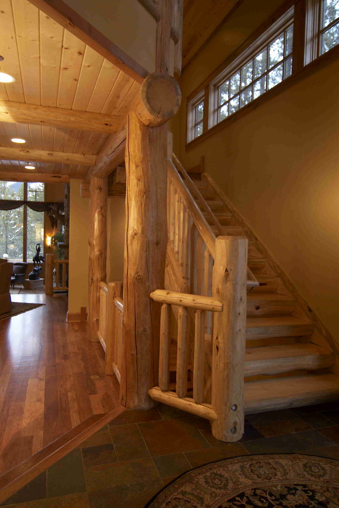 Large mountain style wooden l-shaped open staircase photo in Denver