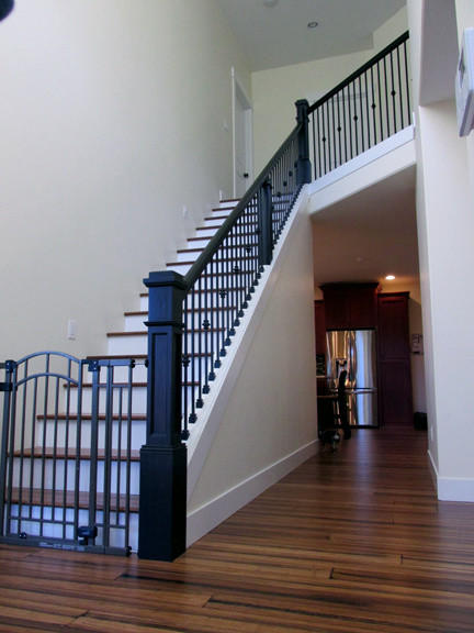 Large country wood straight staircase in Portland with wood risers.