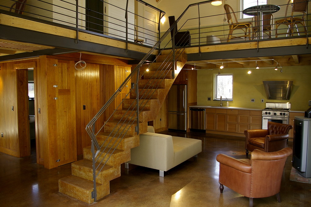 Ejemplo de escalera suspendida rústica de tamaño medio con escalones de hormigón, contrahuellas de hormigón y barandilla de cable