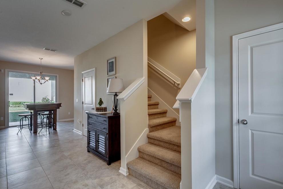 Example of a small classic carpeted l-shaped staircase design in Jacksonville with carpeted risers