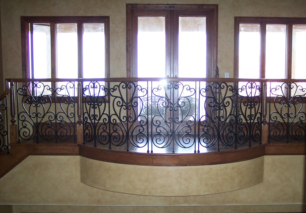 Example of a large tuscan wooden curved staircase design in Tampa with wooden risers