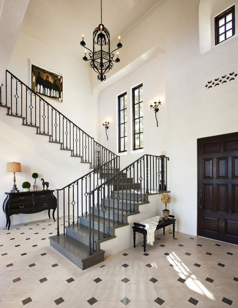 This is an example of a mediterranean l-shaped staircase in Santa Barbara with feature lighting.